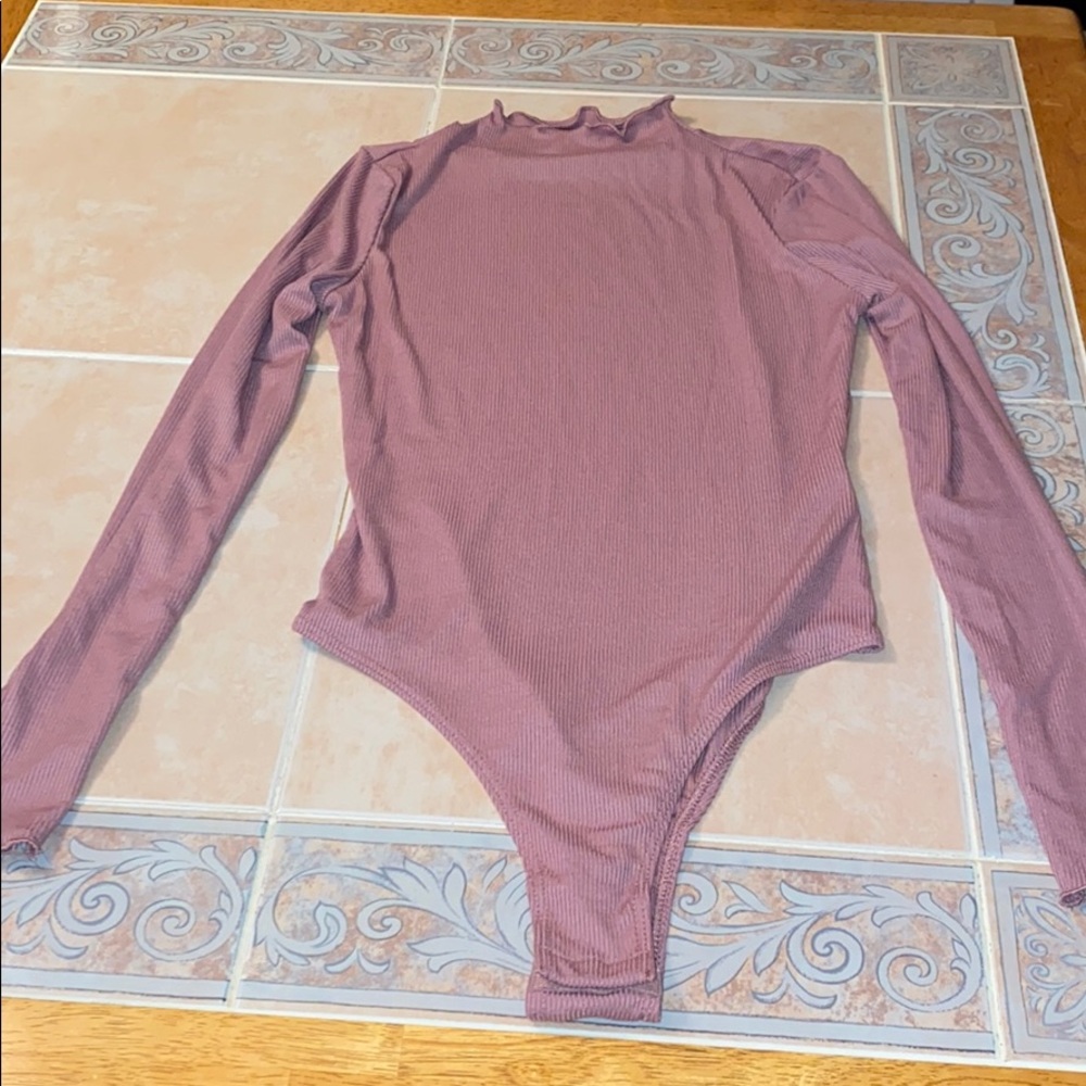 a pink body suit